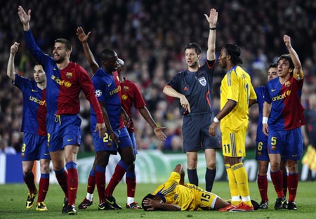 Chelsea's Florent Malouda (bottom) lies injured during their Champions League semi-final first leg soccer match against Barcelona at Nou Camp in Barcelona April 28, 2009.