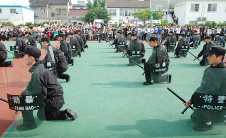 Chinese riot policemen present a demonstration of anti-riot skills for local residents at an open day in Suzhou, east China's Jiangsu Province April 28, 2009. Local police displayed police vehicles, weapons, shields, dogs and presented various skills to the citizens that day.