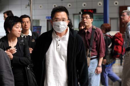 A traveler wearing a mask arrives at Guangzhou East Railway Station in Guangzhou, capital of south China's Guangdong Province, April 29, 2009. An average of nearly 5,000 people arrive at the railway station every day during the the Canton Fair, known as China's largest export event. China has enhanced swine flu prevention and control measures nationwide to prevent possible spread of the disease. (Xinhua/Liu Dawei)