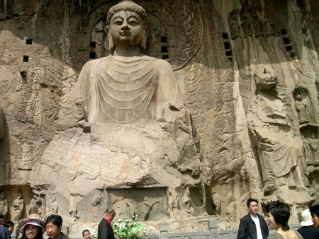 Chinese tourists visit Buddhist statues at the Longmen Grottoes, a world cultural heritage, near Luoyang City in central China's Henan Province, May 2, 2009, the second day of the three-day May Day holiday. China has a totality of 37 world heritages which attract many tourists in the holiday. (Xinhua/Cheng Qianjun)