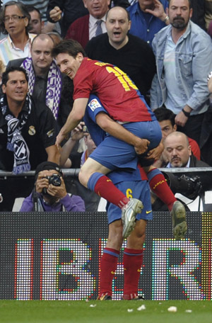 Barcelona&apos;s Lionel Messi (top) celebrates his goal with his team mate Xavi Hernandez during their Spanish first division soccer match against Madrid at Santiago Bernabeu stadium in Madrid May 2, 2009.(Xinhua/Reuters Photo)