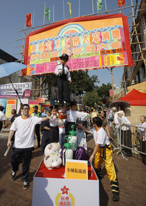 A festival-participating group promotes flu prevention during the Tai Ping Qing Jiao Festival on Cheung Chau island in Hong Kong, South China, May 2, 2009. (Xinhua/Zhou Lei) 