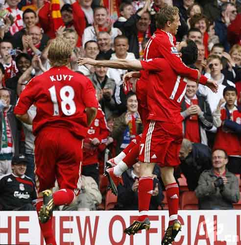 Liverpool's Leiva Lucas (centre) celebrates scoring their third goal with team mate Alvaro Arbeloa.