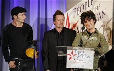Members of the band Green Day (L-R) Mike Dirnt, Tre Cool and Billie Joe Armstrong accept their award at the 25th Anniversary Spirit of Liberty Awards presented by the People for the American Way in Beverly Hills, California October 10, 2006.