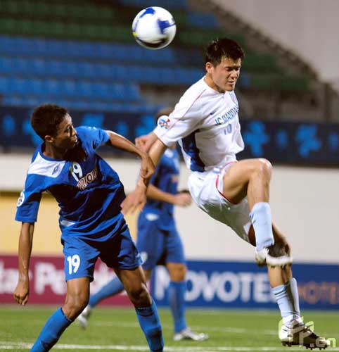 Mustaqim Manzur (L) of Singapore Armed Forces FC and Yu Tao (R) of Shanghai Shenhua competes for the ball during the AFC Champions League Group G match between the Singapore Armed Forces FC and Shanghai Shenhua at Jalan Besar Stadium on May 5, 2009 in Kallang, Singapore.