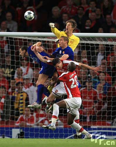 Manchester United's goalkeeper Edwin Van der Sar punches clear whilst under pressure. 