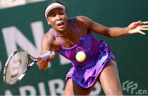 Venus Williams of the United States serves the ball to Czech Republic's Lucie Safarova during their match at the Rome Masters tennis tournament in Rome, Italy, Monday, May 4, 2009.