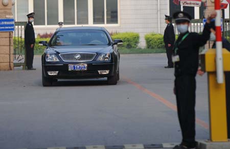 A car carrying the quarantined passengers from the Mexico City-Shanghai flight AM098, where a Mexican man was confirmed to be infected with influenza A/H1N1, runs out of the gate of the Guomenlu Hotel in Beijing, China, May 7, 2009. The passengers quarantined in the Chinese mainland who took the same flight with the Mexican were out of quarantine on Thursday.