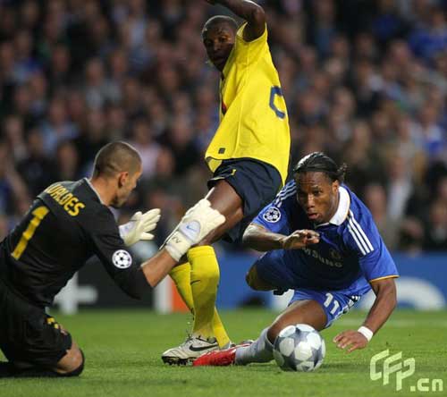 Chelsea's Didier Drogba goes down under a tackle by Barcelona's Eric Abidal in the penalty box. The match ended in a 1-1 draw, with Barcelona qualifying on away goals.