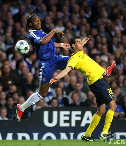 Chelsea's Didier Drogba (left) and Barcelona's Sergio Busquets (right) battle for the ball