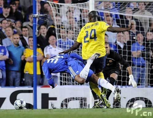 Chelsea's Nicolas Anelka goes down under a tackle by Barcelona's Yaya Toure in the penalty box. 