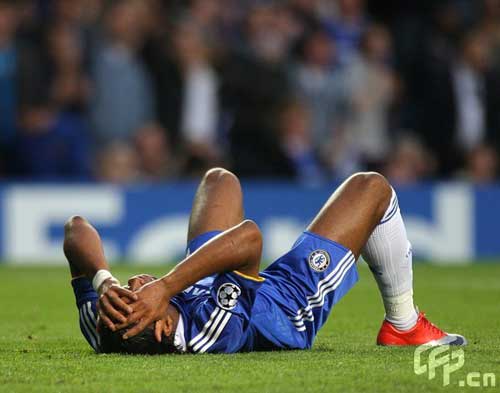 Chelsea's Didier Drogba lays dejected on the ground after having a penalty appeal