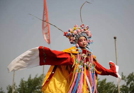 An actress performs "Beigun", a traditional folk art usually held to pray for harvest and peace, during a folk cultural carnival in Taiyuan, capital of north China
