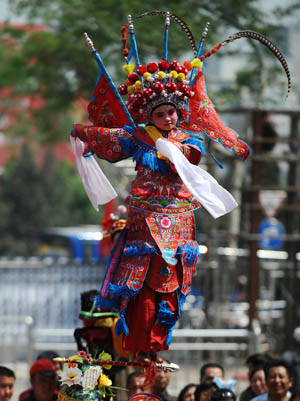 An actress performs "Beigun", a traditional folk art usually held to pray for harvest and peace, during a folk cultural carnival in Taiyuan, capital of north China