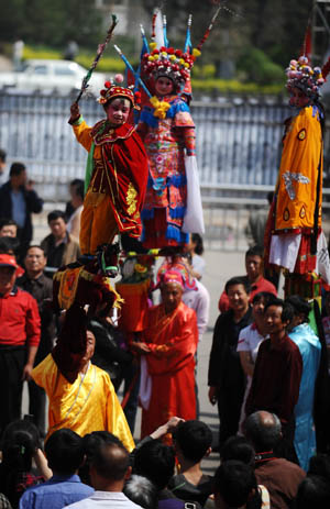 Folk actors perform "Beigun", a traditional folk art usually held to pray for harvest and peace, during a folk cultural carnival in Taiyuan, capital of north China