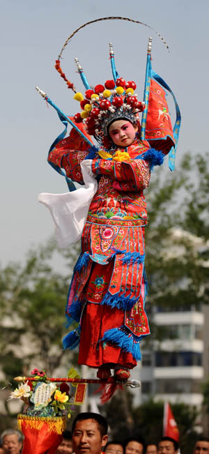 An actress performs "Beigun", a traditional folk art usually held to pray for harvest and peace, during a folk cultural carnival in Taiyuan, capital of north China