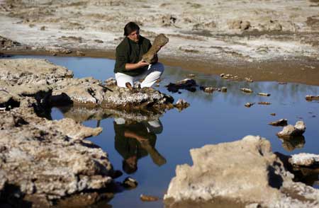 Gustavo Lara, Director of Culture of the town of Roque Perez, holds a fossil bone of a megatherium, a kind of large ground sloth, at an excavation site on the outskirts of Roque Perez, some 135 km (84 miles) south of Buenos Aires, May 6, 2009. Fossil bones of nine glossopteris, a glyptodont, the nearly complete skeleton of a megatherium and a head of a stegomastodon dated from the Pleistocene, the epoch from 1.8 million to 10000 years ago, were found by paleontologists in the sediments of the Salado River due to a drought that has been affecting the area for months, local media reported.