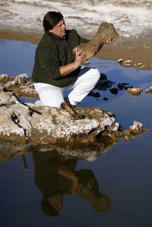 Gustavo Lara, Director of Culture of the town of Roque Perez, holds a fossil bone of a megatherium, a kind of large ground sloth, at an excavation site on the outskirts of Roque Perez, some 135 km (84 miles) south of Buenos Aires, May 6, 2009. Fossil bones of nine glossopteris, a glyptodont, the nearly complete skeleton of a megatherium and a head of a stegomastodon dated from the Pleistocene, the epoch from 1.8 million to 10000 years ago, were found by paleontologists in the sediments of the Salado River due to a drought that has been affecting the area for months, local media reported.