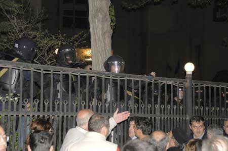 Georgian special police forces stand behind fence during a clash with opposition supporters in Tbilisi, caital of Georgia, May 6, 2009. Georgian opposition supporters gathered to block a main police building and clashed with the police here Wedneday as political tensions mounted. (Xinhua/Guo Qun)
