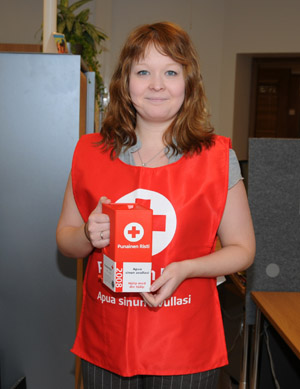 A member of Finnish Red Cross holds a pot to collect donations in Helsinki, Finland, May 5, 2009. May 8 is the World Red Cross Day. Finnish Red Cross held a 6-day campaign that started on Monday to publicize the organization and recruit volunteers.