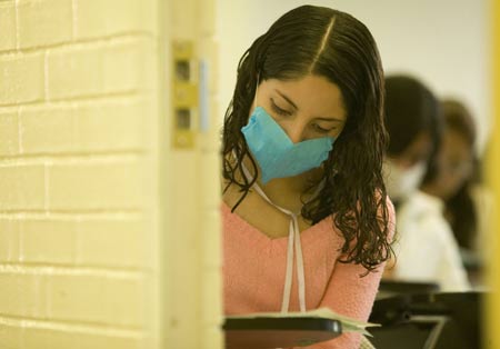 A student wearing a mask attends a class at the National Autonomous University of Mexico (NAUM) in the Mexico City May 7, 2009. All high schools and universities in Mexico, suspended classes due to the A/H1N1 flu epidemic, resumed classes on Thursday as the government said the worst of the flu crisis is over. (Xinhua)