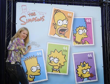 Nancy Cartwright, the voice of Bart Simpson, signs a poster at the unveiling of the new 'The Simpsons' U.S. postage stamps in Los Angeles May 7, 2009. Nancy Cartwright, the voice of Bart Simpson, signs a poster at the unveiling of the new 'The Simpsons' U.S. postage stamps in Los Angeles May 7, 2009.