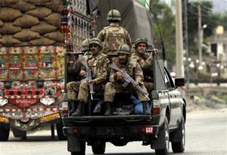 Pakistani soldiers are seen on their way to Pakistan's troubled valley of Swat where government security forces are fighting with Taliban militants, in Mardan near Peshawar, Pakistan on Wednesday, May 6, 2009. [Mohammad Sajjad/AP Photo] 