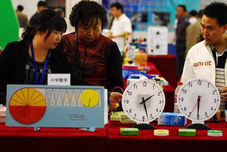  Visitors view educational instruments for maths displayed at the 57th China National Exhibition of Educational Instruments held in Yantai, east China's Shandong Province, May 10, 2009. More than 800 producers took part in the exhibition opened here Sunday. [Xinhua]