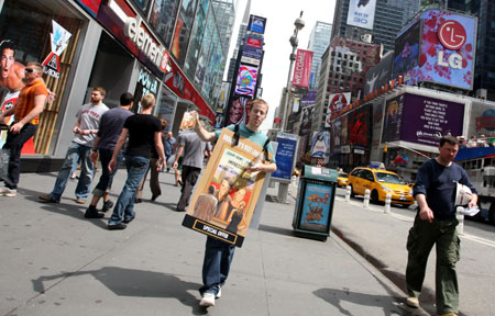 A sandwich-board wearer hands out coupons of a Broadway show at Broadway around Times Square in New York May 8, 2009.