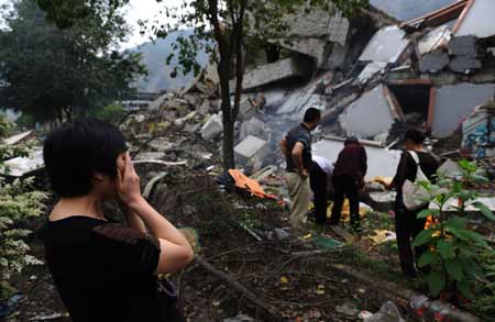 A mother mourns for her child who was killed in last year's May 12 earthquake in Beichuan, a hardest-hit area in the disaster, in southwest China's Sichuan Province, on May 10, 2009. Parents who lost their children came back to Beichuan as the first anniversary of the disaster approaches. [Jiang Hongjing/Xinhua]