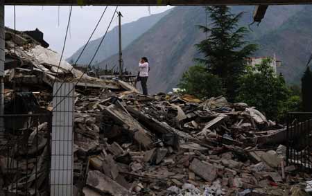  A mother mourns for her child who was killed in last year's May 12 earthquake in Beichuan, the hardest-hit area in the disaster, in southwest China's Sichuan Province, on May 10, 2009. Parents who lost their children came back to Beichuan as the first anniversary of the disaster approaches. [Jiang Hongjing/Xinhua]