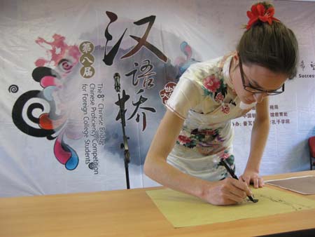 A contestant draws a traditional Chinese painting during the French round of the 'Chinese Bridge' competition, a Chinese-language proficiency contest for foreign college students, in Poitiers, France, on May 9, 2009. The two winners of the contest held here on Saturday will attend the final of the 'Chinese Bridge' competition, which would be held this July in Changsha, central China's Hunan Province. [Li Xuemei/Xinhua] 