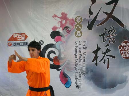 A contestant performs Chinese martial arts during the French round of the 'Chinese Bridge' competition, a Chinese-language proficiency contest for foreign college students, in Poitiers, France, on May 9, 2009. The two winners of the contest held here on Saturday will attend the final of the 'Chinese Bridge' competition, which would be held this July in Changsha, central China's Hunan Province. [Li Xuemei/Xinhua]