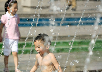 A little boy tries to cool himself down in the fountain at People's Square in Shanghai yesterday. [Zhang Suoqing/Shanghai Daily] 