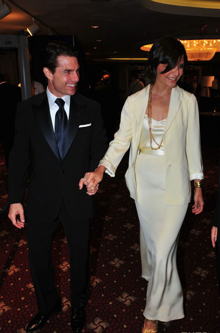 Tom Cruise and Katie Holmes pose for pictures on their way into the White House Correspondents Dinner on Saturday night (May 9) in Washington, D.C.