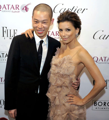 Actress Eva Longoria Parker (R) and fashion designer Jason Wu, who designed Michelle Obama's inaugural gown, pose for photographers on the red carpet at the Capitol File Magazine After Party for the White House Correspondents Dinner, at the Corcoran Museum, in Washington, May 9, 2009.