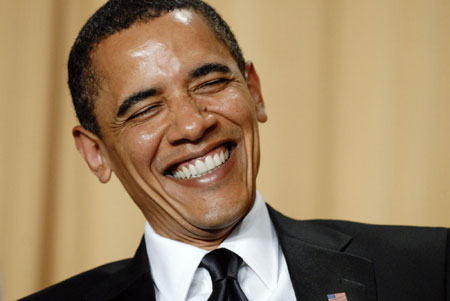 U.S. President Barack Obama laughs during actress Wanda Sykes' comedy routine at the White House Correspondents' Association Dinner in Washington May 9, 2009.