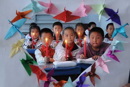 Pupils attend an activity commemorating the victims of the May 12 earthquake last year, at Qiantang Primary School in Harbin, capital of northeast China&apos;s Heilongjiang Province, May 11, 2009. As the first anniversary of the earthquake approaches, people all over China commemorate the disaster in different ways.[Xinhua] 