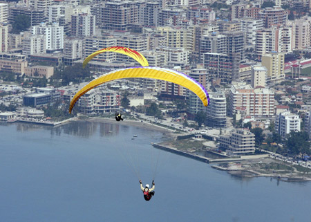  Paragliders fly over the city of Vlore during an annual Balkan competition, some 150 km (94 miles) from the capital Tirana, May 9, 2009.[Xinhua/Reuters]