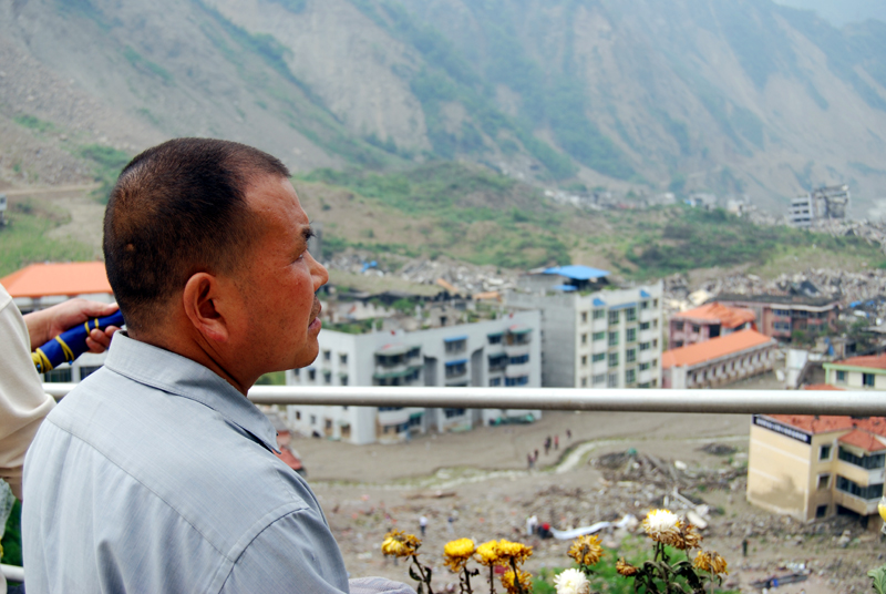 A man looks out over the ruins of Beichuan on May 11, 2009. [John Sexton/China.org.cn]