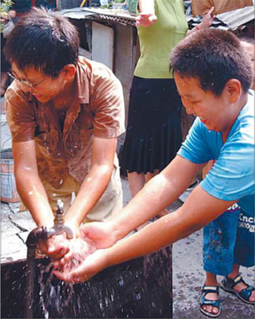 File photo shows children in a Beijing locality wash their hands with tap water. [China Daily]
