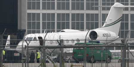 A German police vehicle drives in front of a jet carrying suspected Nazi death camp guard John Demjanjuk, 89, after his arrival at Munich's International Airport, May 12, 2009.[Xinhua/Reuters]