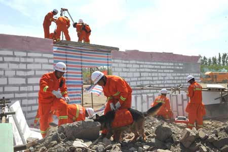 Firefighters attend a quake rescue drill in Yinchuan, capital of Ningxia Hui Autonomous Region, northwest China, May 12, 2009, China's first National Disaster Prevention and Reductin Day on the occasion of the first anniversary of the May 12, 2008 Wenchuan earthquake.[Xinhua]