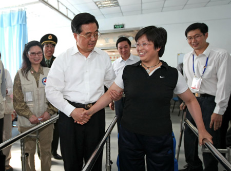 C Chinese President Hu Jintao helps a handicapped woman caused by the quake of last year in a rehabilitation center in Deyang, southwest China's Sichuan province. Hu Jintao and vice Premier Li Keqiang visited the reconstruction projects in the quake-hit places in southwest China's Sichuan province on May 11 and May 12, 2009. (Xinhua/Ju Peng) 