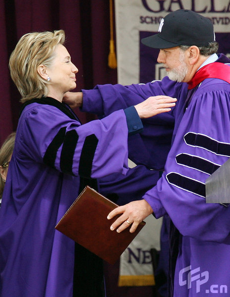 Secretary of State Hillary Rodham Clinton is congratulated by John Sexton, president of New York University, as she receives an honorary Doctor of Law degree during NYU's graduation ceremony held at Yankee Stadium on May 13, 2009 in New York.[CFP]