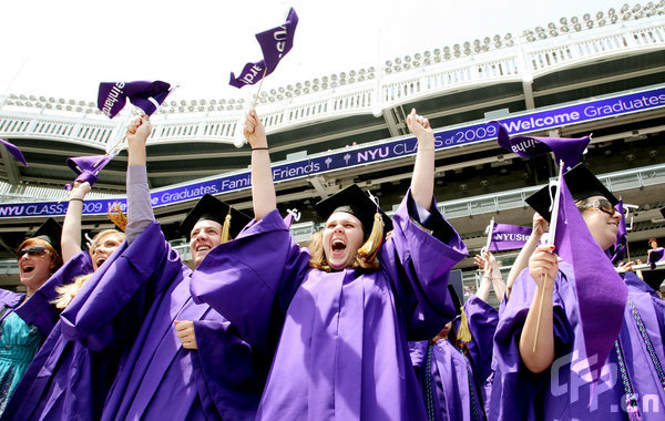 Graduates cheer during New York University's graduation ceremony held at Yankee Stadium on May 13, 2009 in New York.[CFP]