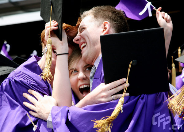 Students congratulate one another upon the conclusion of New York University's graduation ceremony held at Yankee Stadium on May 13, 2009 in New York.[CFP]