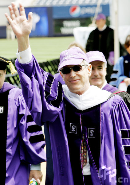 Playwright John Patrick Stanley waves to the cheering crowd during New York University's graduation ceremony where he received a honorary Doctorate degree during the ceremony held at Yankee Stadium on May 13, 2009 in New York.[CFP]