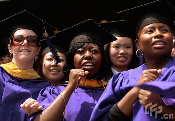 Graduate candidates in the nursing program wait to be conferred their degrees during the 177th commencement exercises for New York University (NYU) at Yankee Stadium May 13, 2009 in the Bronx borough of New York City. U.S. Secretary of State Hillary Rodham Clinton recieved an honorary degree and addressed the graduates about public service and their future in a changing world.[CFP]