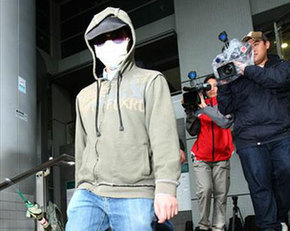 Computer technician Dicky Sze Ho-chun walks out of the Kowloon city law court building, Hong Kong, April 6, 2009. 